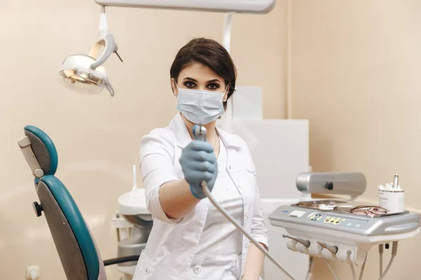 Closeup photo of female doctor in the dentist cabinet.