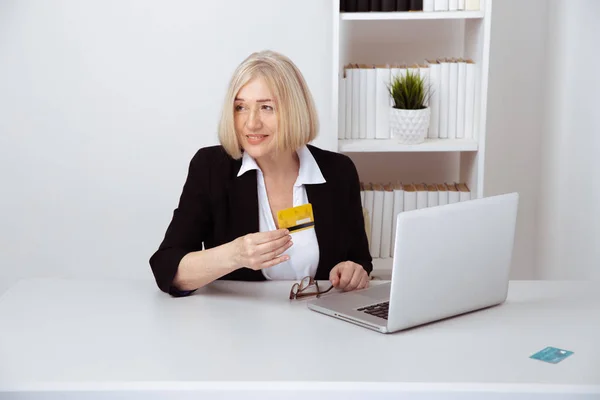 Office woman having shopping on the computer by credit card.