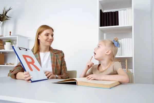 Speech therapy concept. Patient kid with female therapist training pronunciation. — Stock Photo, Image