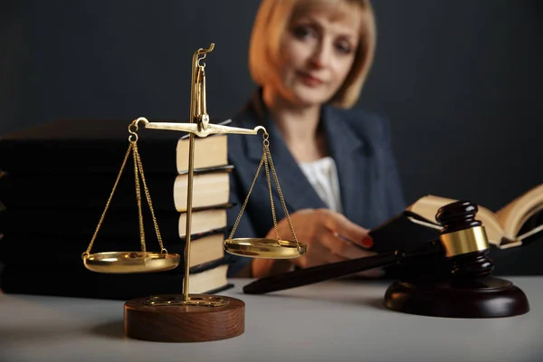 Woman judje isolated in office with books and justice scales and wooden gavel. — Stock Photo, Image