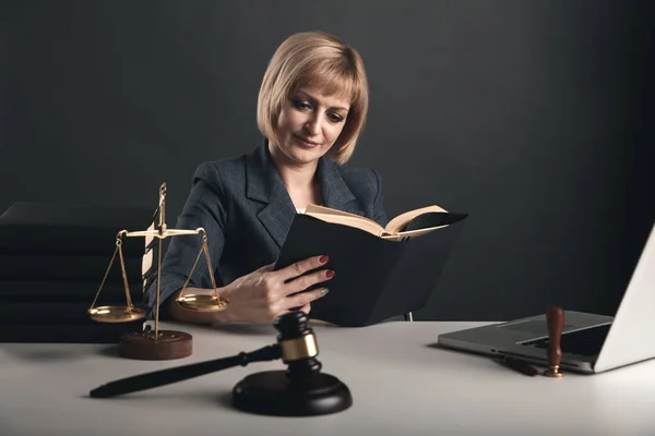 Mulher advogado com livros aabout lei no escritório sentado na mesa . — Fotografia de Stock
