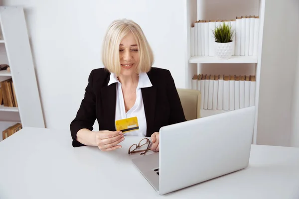 Office woman having shopping on the computer by credit card.