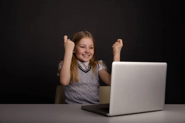 Cute happy girl watching computer and feeling so glad isolated.