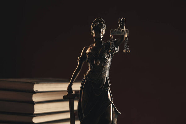Bronze Statue Of Justice on the desk isolated. Notary concept.