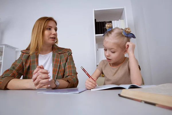 Doing tasks and studying concept. Sitter with girl writing homework. — Stock Photo, Image