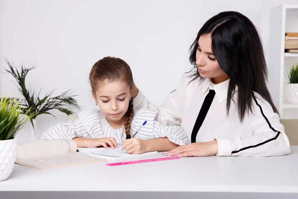 母と子供は座って学ぶことで一緒に時間を過ごす. — ストック写真