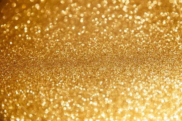 Goldglitzernde Weihnachtsbeleuchtung. Verschwommener abstrakter Hintergrund — Stockfoto