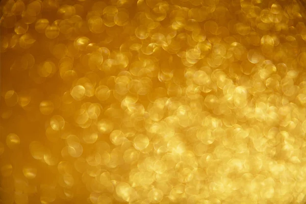 Luzes de Natal brilhantes douradas. Fundo abstrato desfocado — Fotografia de Stock