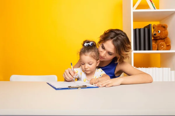Mother and kid spending time together by sitting and learning. — Stock Photo, Image