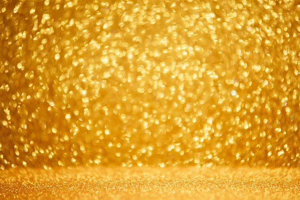 Złote błyszczące lampki świąteczne. Zamazane abstrakcyjne tło — Zdjęcie stockowe
