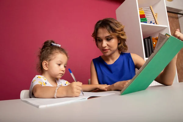 Mother and kid spending time together by sitting and learning. — Stock Photo, Image