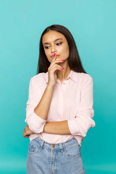 Young attractive woman in think pose isolated.