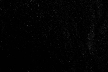 Siyah arkaplan üzerinde yüzen soyut gerçek toz