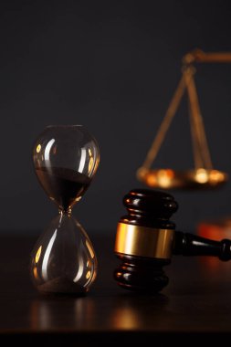 Hakimler tokmak, adalet terazisi ve ahşap masada kum saati. Hukuk ve adalet kavramı