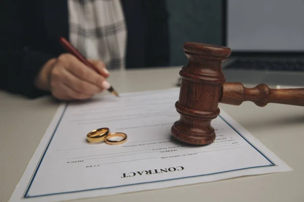 Hands of wife, husband signing decree of divorce, dissolution, canceling marriage, legal separation documents, filing divorce papers or premarital agreement prepared by lawyer. Wedding ring — Stock Photo, Image