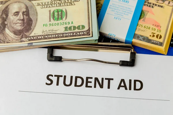 Statement form of student aid and money on the table.