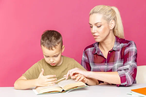 Remote education. Home education for children. Mom helps son to learn