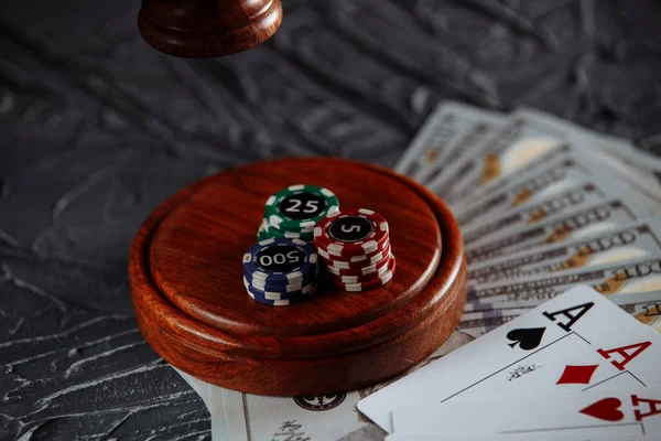 Online gambling and justice theme, cards and judge gavel on old grey table