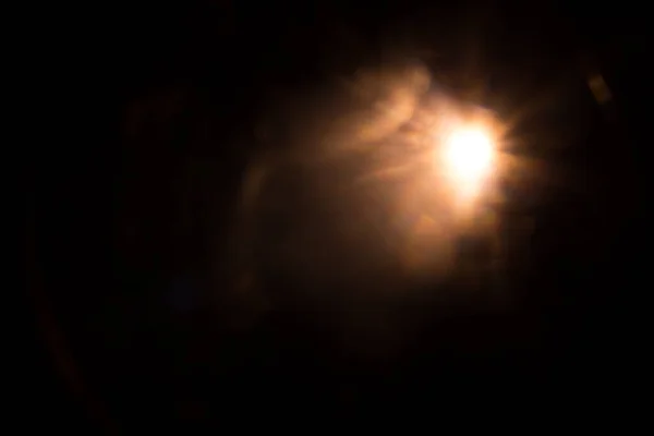 Solar lens flare on black background — Stock Photo, Image