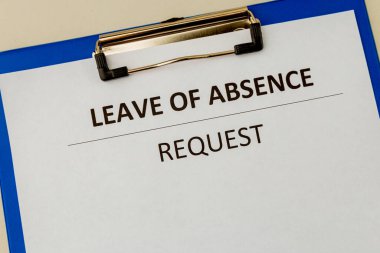 Leave of absence request on the tablet at the table. clipart