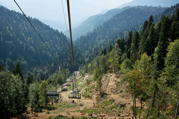cable car with open seats in the mountains. the view from the top