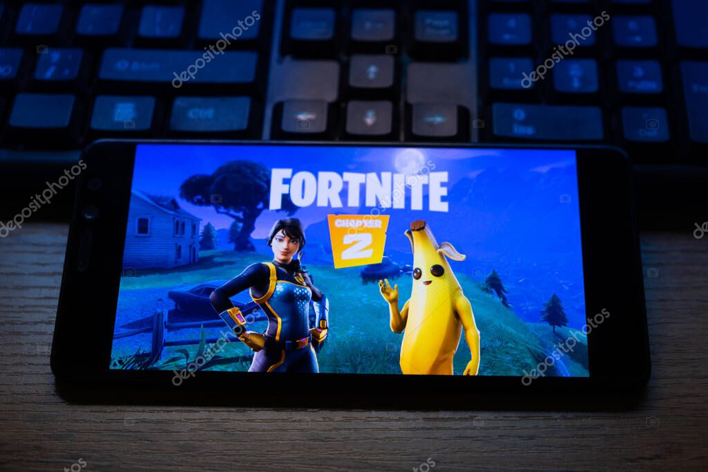 Kostanay, Kazakhstan, October 15, 2019.Mobile phone on the background of the keyboard, with the logo of the popular game fortnite 2, from Epic Games.
