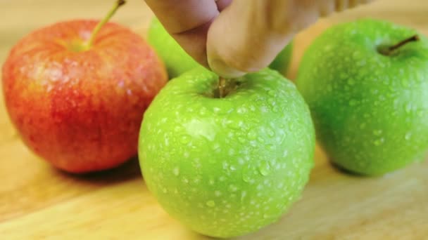 Färskt Grönt Äpple Med Daggdroppar Man Tar Det Med Fingrarna — Stockvideo