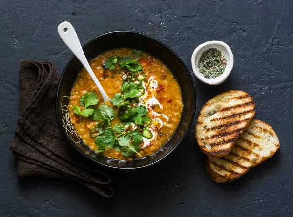 Curried red lentil tomato and coconut soup - delicious vegetarian food on dark background, top view — Stock Image Curried Red Lentil Tomato Coconut Soup Delicious Vegetarian Food Dark Stock Image