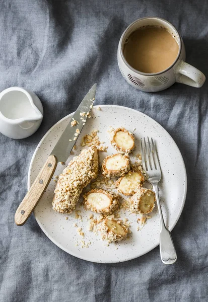 Healthy protein snack, breakfast - peanut butter, seeds, banana nut bites on a grey background, top view