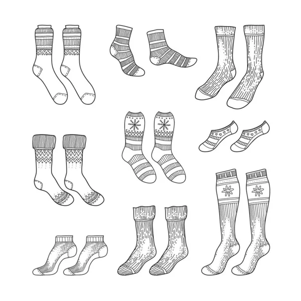 Black engraved socks drawing. Winter warm Christmas stockings set in ink hand drawn style vector illustration — Stock Vector