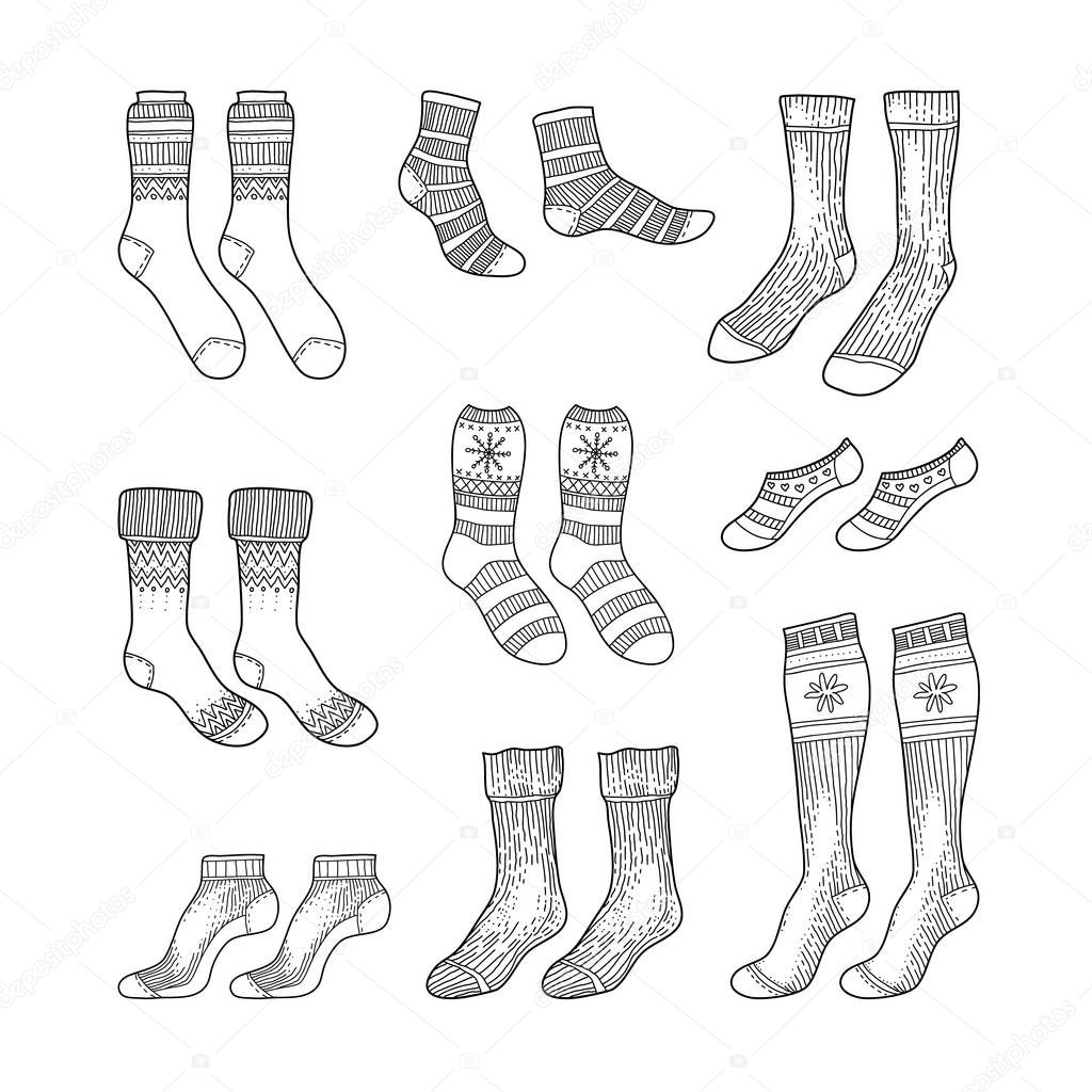 Black engraved socks drawing. Winter warm Christmas stockings set in ink hand drawn style vector illustration