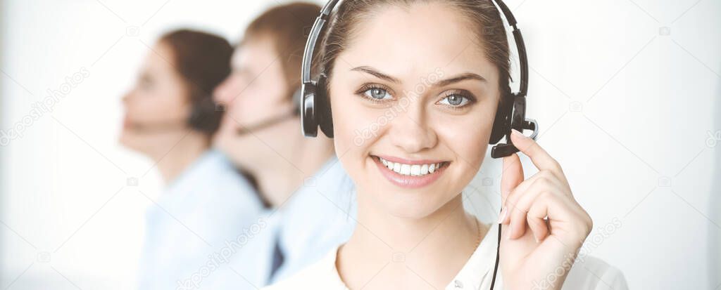 Call center. Diverse customer service operators in headsets at work in office. Business concept
