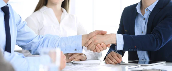 Business people shaking hands at meeting or negotiation, close-up. Group of unknown businessmen and women in modern office. Teamwork, partnership and handshake concept, toned picture — Stock Photo, Image