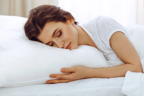 Beautiful young woman sleeping while lying in her bed. Concept of pleasant and rest reinstatement for active life — Stock Photo, Image