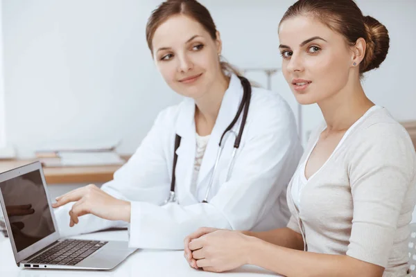 Lekarz i pacjent siedzą i omawiają wyniki badań zdrowotnych podczas korzystania z laptopa. Opieka zdrowotna, medycyna i dobre wiadomości — Zdjęcie stockowe