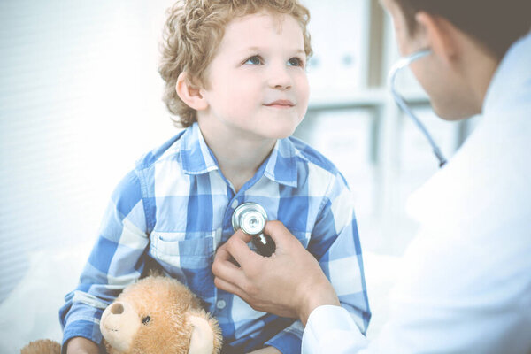 Doctor and patient child. Physician examining little boy. Regular medical visit in clinic. Medicine and health care concept