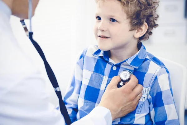 Arzt und geduldiges Kind. Arzt untersucht kleinen Jungen. Regelmäßiger Arztbesuch in der Klinik. Medizin und Gesundheitskonzept — Stockfoto