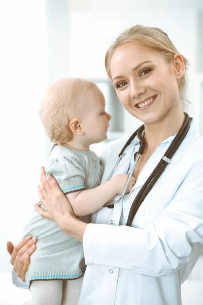 Doctor and patient in hospital. Little girl is being examined by doctor with stethoscope. Medicine concept