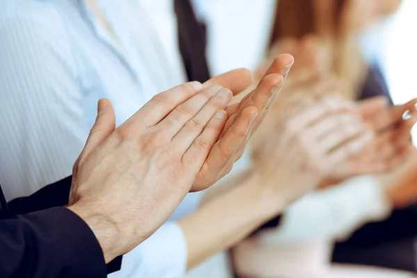 Business people clapping and applause at meeting or conference, close-up of hands. Group of unknown businessmen and women in modern white office. Success teamwork or corporate coaching concept — Stock Photo, Image