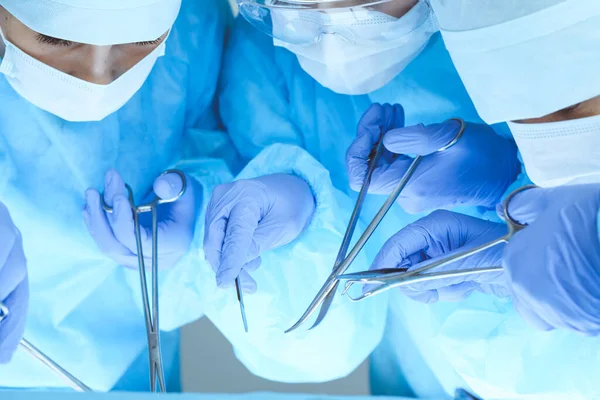 Close-up of medical team performing operation. Group of surgeons at work are busy of patient. Medicine, veterinary or healthcare and emergency in hospital — Stock Photo, Image