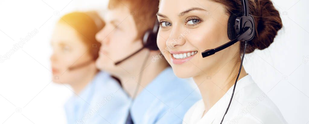 Call center. Diverse customer service operators in headsets at work in office. Business concept