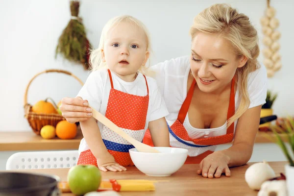 Happy mother and little daughter cooking in kitchen. Spending time all together, family fun concept — Stock Photo, Image