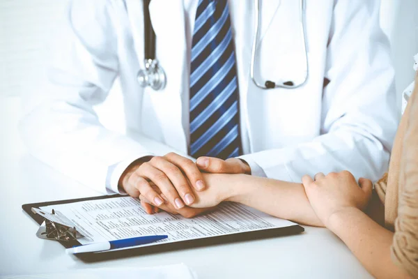 Hand of doctor reassuring her female patient. Concepts of medical ethics and trust in medicine — Stock Photo, Image