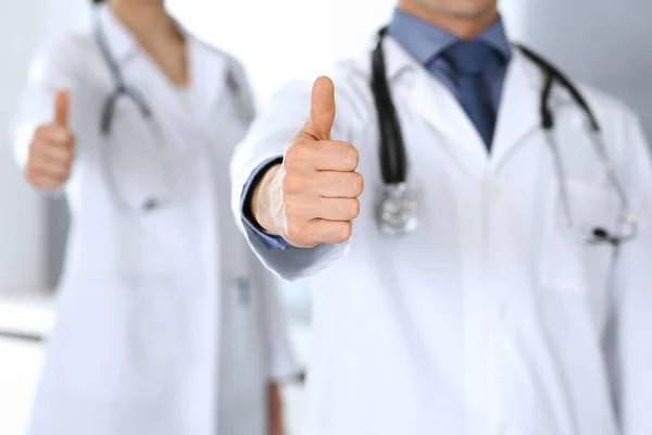 Group of doctors showing thumbs up. Perfect medical service in clinic. Happy future in medicine and healthcare concept — Stock Photo, Image