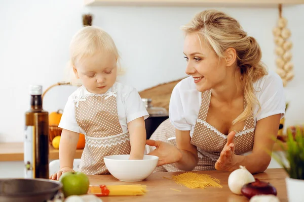 Happy mother and little daughter cooking in kitchen. Spending time all together, family fun concept — Stock Photo, Image