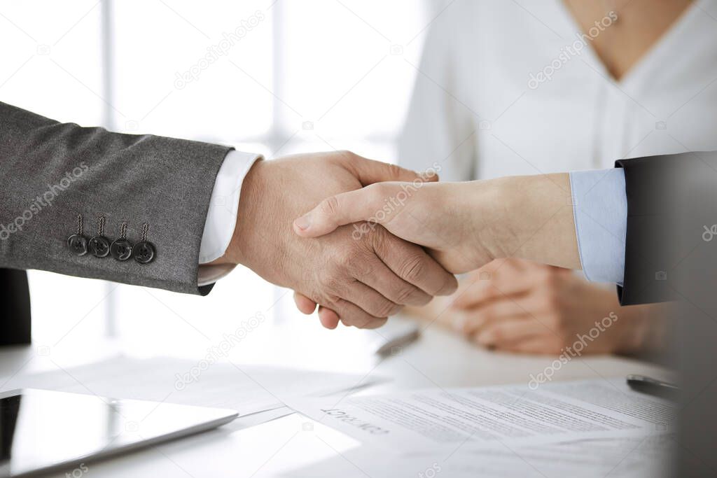 Business people shaking hands finishing contract signing, close-up. Business communication concept. Handshake and marketing