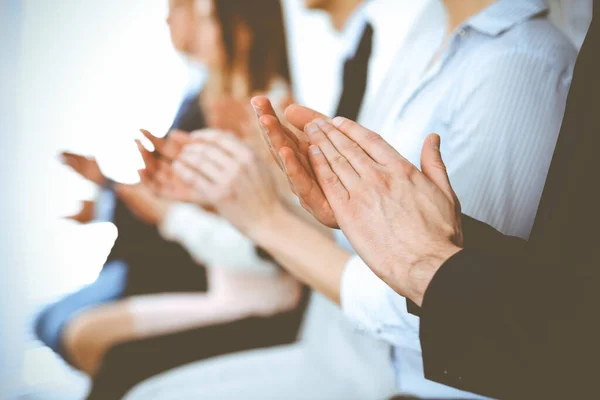 Business people clapping and applause at meeting or conference, close-up of hands. Group of unknown businessmen and women in modern white office. Success teamwork or corporate coaching concept — Stock Photo, Image