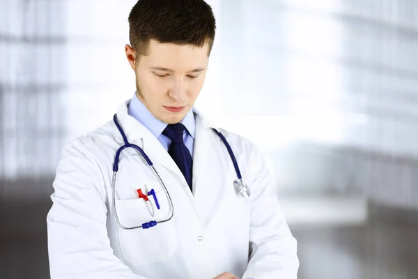 Der Arzt steht mit einem Stethoskop in seinem Krankenhauszimmer. Perfekte medizinische Versorgung in der Klinik. Glückliche Zukunft in Medizin und Gesundheitswesen — Stockfoto