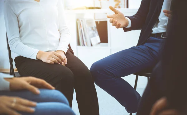 Group of people sitting in a circle during therapy in sunny office. Meeting of business team participating in training — Stock Photo, Image