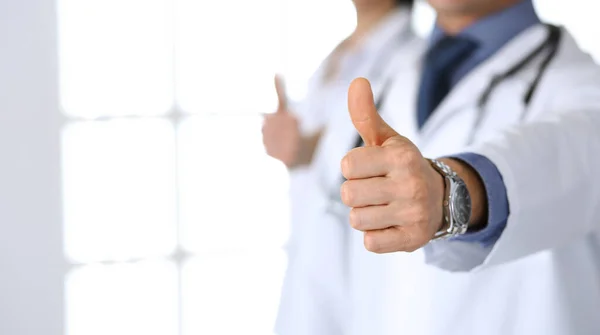 Group of doctors showing thumbs up. Perfect medical service in clinic. Happy future in medicine and healthcare concept — Stock Photo, Image